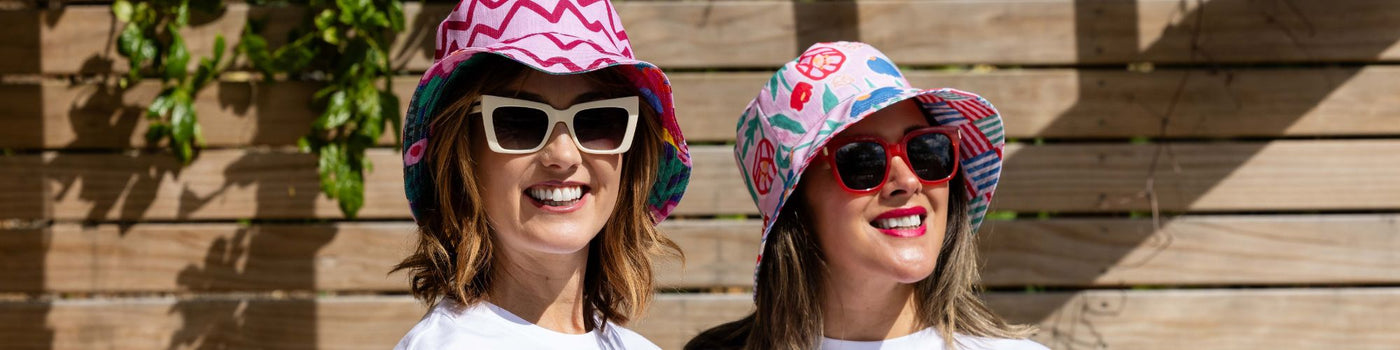 Three women wearing hats and t - shirts.